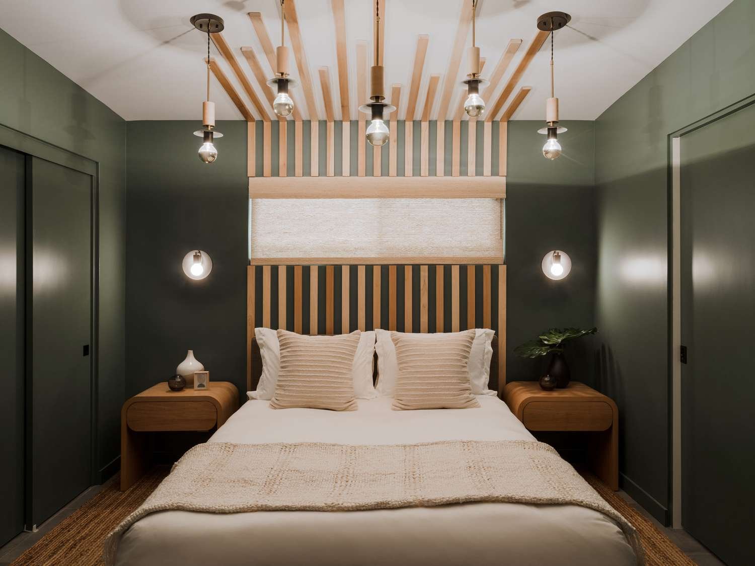 dormitorio verde oscuro con muebles de madera clara