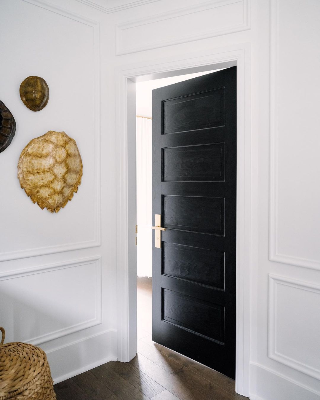puerta negra con herrajes de latón